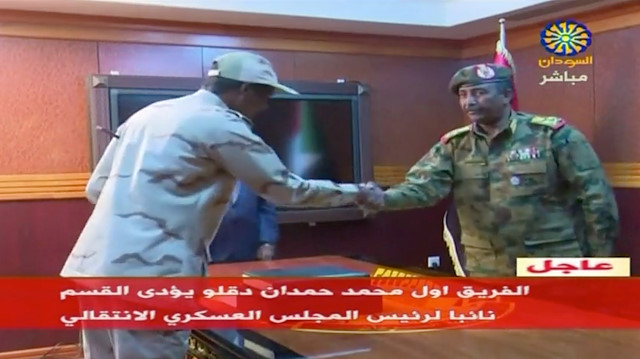 Sudan's General Abdelfattah Mohamed Hamdan Dagalo, known as "Hemeti", head of the Rapid Support Forces, is sworn-in as the appointed deputy of Sudan's transitional military council, standing before the head of transitional council, Lieutenant General Abdel Fattah Al-Burhan Abdelrahman (R) in Khartoum, Sudan April 13, 2019 in this still image taken from video. Sudan TV/ReutersTV via REUTERS ATTENTION EDITORS - THIS IMAGE HAS BEEN SUPPLIED BY A THIRD PARTY. SUDAN OUT. NO COMMERCIAL OR EDITORIAL SALES IN SUDAN. TV Restrictions: Broadcasters: NO USE SUDAN Digital: NO USE SUDAN . For Reuters customers only.


