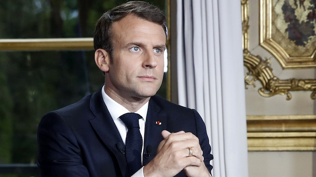 French President Emmanuel Macron gestures while addressing the French nation 