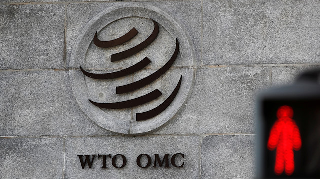 FILE PHOTO: A logo is pictured outside the World Trade Organization (WTO) headquarters next to a red traffic light in Geneva, Switzerland, October 2, 2018. REUTERS/Denis Balibouse/File Photo

