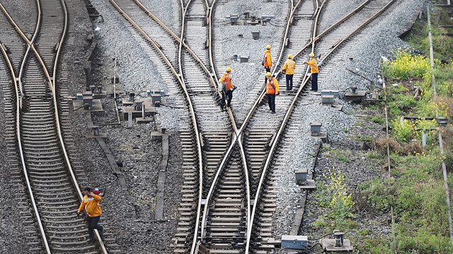 FILE PHOTO: Workers inspect railway tracks, which serve as a part of the Belt and Road freight rail route linking Chongqing to Duisburg, at the Dazhou railway station in Sichuan province, China March 14, 2019