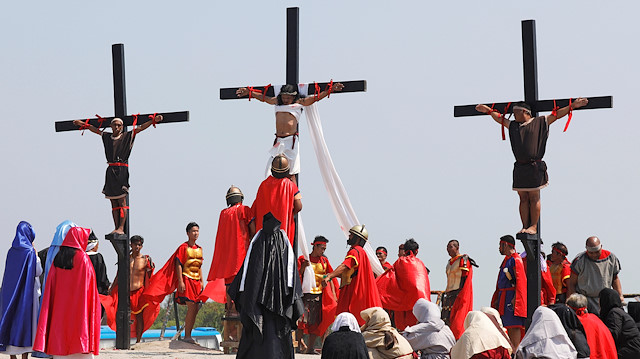 Filipino devotees are nailed on wooden crosses during a crucifixion re-enactment on Good Friday, in San Fernando City, Pampanga province, Philippines, April 19, 2019.