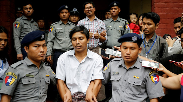 Detained Reuters journalist Kyaw Soe Oo and Wa Lone are escorted by police