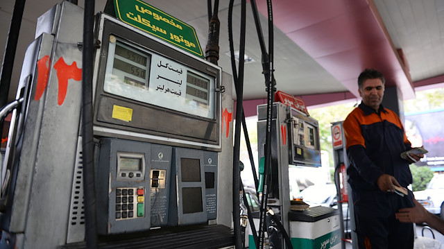File photo: People are seen at a petrol station in Iran