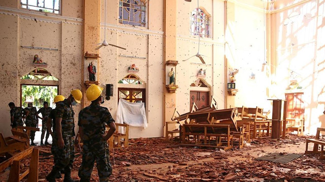 Police officers work at the scene at St. Sebastian Catholic Church, after bomb blasts ripped through churches and luxury hotels on Easter, in Negombo, Sri Lanka April 22, 2019.