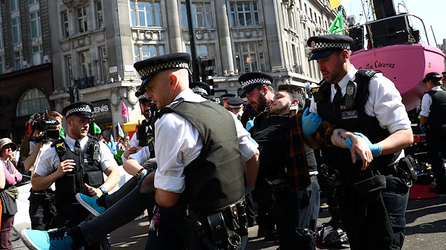 File photo: Police officers detain a climate change activist 