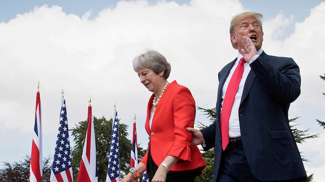 File photo: U.S. President Donald Trump walks with Britain's Prime Minister Theresa May