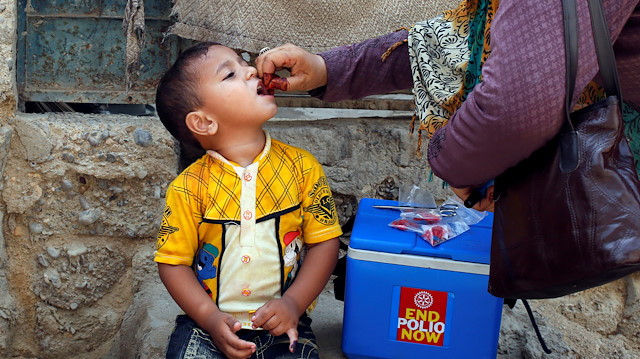 File photo:  A boy receives polio vaccine drops in Pakistan