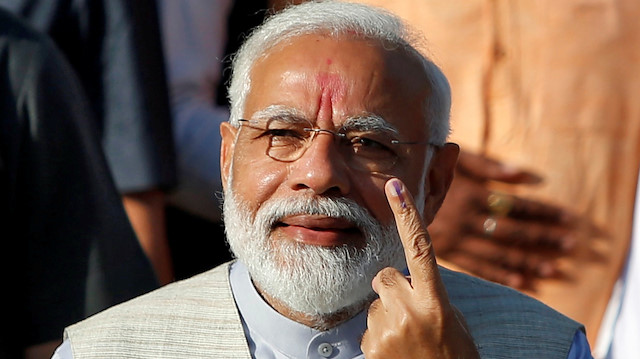 India's Prime Minister Narendra Modi shows his ink-marked finger after casting his vote outside a polling station during the third phase of general election in Ahmedabad, India, April 23, 2019. REUTERS/Amit Dave

