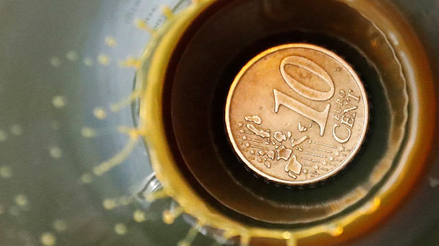File photo: A view shows a 10 Euro cent coin is seen inside a bulb with crude oil at a laboratory 