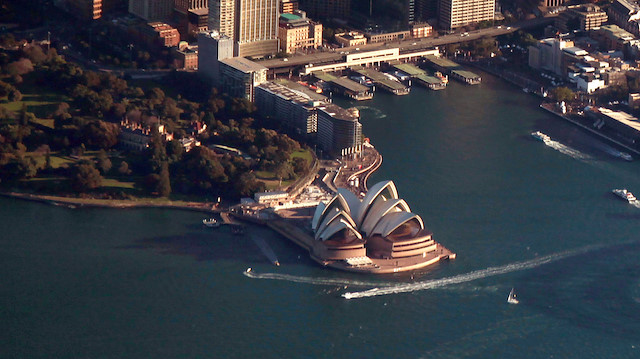 - The Sydney Harbour Bridge casts a shadow next to the Sydney Opera House 