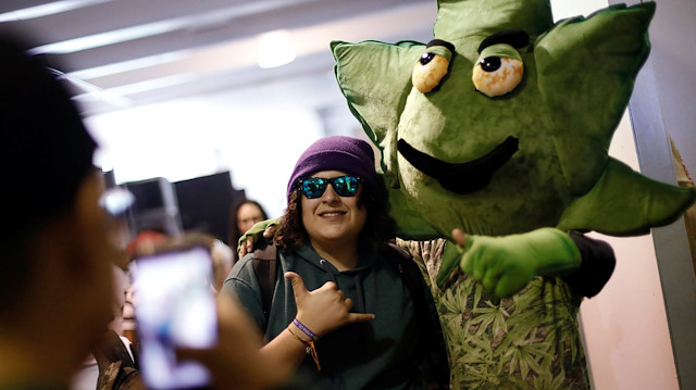 A visitor poses for a photo during the first day of the annual Cannabis Expo in Mexico City, March 30, 2019. REUTERS/Edgard Garrido

