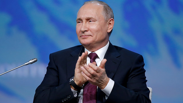  Russian President Vladimir Putin applauds 