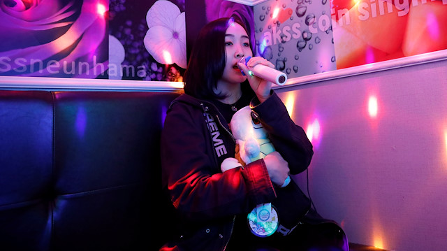 Japanese Yuuka Hasumi, 17, who wants to become a K-pop star, sings a song as she spends time after class, in the Hongdae area of Seoul, South Korea, April 3, 2019. Hasumi put high school in Japan on hold and flew to South Korea in February to try her chances at becoming a K-pop star, even if that means long hours of vocal and dance training, no privacy, no boyfriend, and even no phone. "It is tough," Hasumi said. "Going through a strict training and taking my skill to a higher level to a perfect stage, I think that's when it is good to make a debut." 