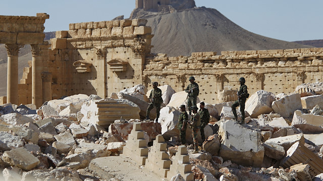 FILE PHOTO - Syrian army soldiers stand on the ruins of the Temple of Bel in the historic city of Palmyra, in Homs Governorate, Syria April 1, 2016. REUTERS/Omar Sanadiki/File Photo  