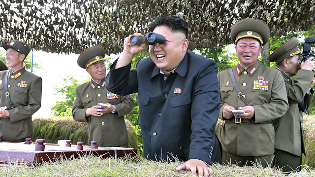 North Korean leader Kim Jong Un looks through a pair of binoculars during an inspection of the Hwa Islet Defence Detachment standing guard over a forward post off the east coast of the Korean peninsula, in this undated file photo released by North Korea's Korean Central News Agency (KCNA) in Pyongyang on July 1, 2014. North Korea fired two short-range ballistic missiles into the sea off its east coast city of Wonsan early on March 10, 2016 flying approximately 500 km (300 miles), South Korea's military said. 