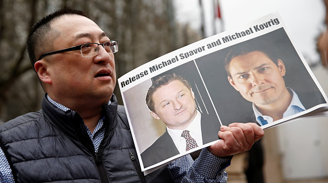 Louis Huang holds a placard ccalling for China to release Canadian detainees Michael Spavor and Michael Kovrig outside a court hearing for Huawei Technologies Chief Financial Officer Meng Wanzhou at the B.C. Supreme Court in Vancouver, British Columbia, Canada
