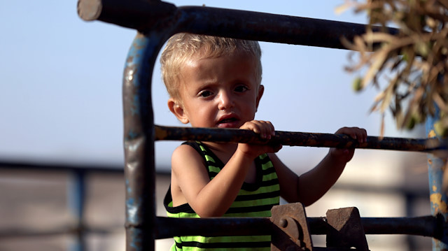 File photo: A newly displaced Syrian child arrives with his family at a refugee camp 