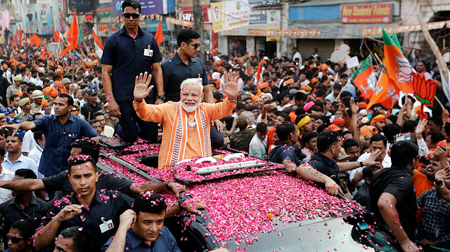 File photo: India's Prime Minister Narendra Modi waves towards his supporters during a roadshow