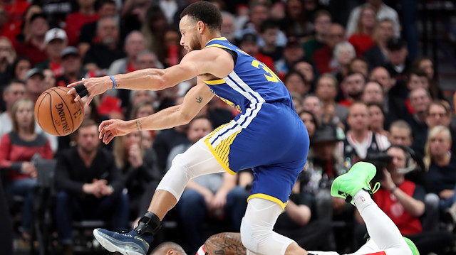 May 18, 2019; Portland, OR, USA; Portland Trail Blazers guard Damian Lillard (0) falls to the floor while defending Golden State Warriors guard Stephen Curry (30) in the first half of game three of the Western conference finals of the 2019 NBA Playoffs at Moda Center. Mandatory Credit: Jaime Valdez-USA TODAY Sports


