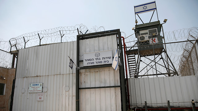 File photo: An Israeli flag is seen next to the gate of the Megiddo Prison in northern Israel