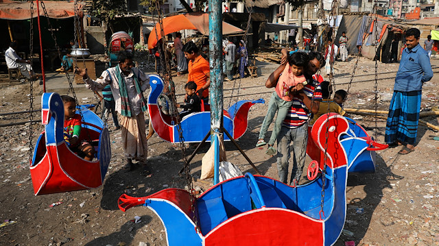 Children ride a merry-go-round in Dhaka, Bangladesh February 4, 2019. REUTERS/Mohammad Ponir Hossain  