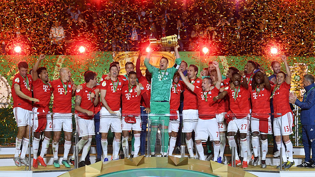 Bayern Munich's Manuel Neuer celebrates winning the DFB Cup with team mates 