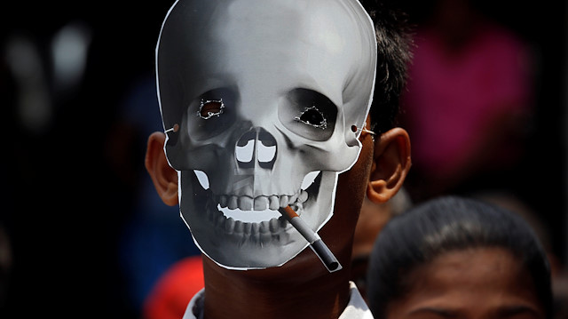 File photo: A child wearing a skull mask attends an anti-tobacco awareness rally during the World No Tobacco Day in Kolkata, India