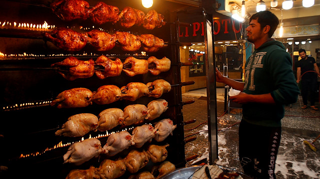 An Iraq man roasts chickens at a roadside restaurant in Karada district of Baghdad, Iraq February 22, 2019. Picture taken February 22, 2019. REUTERS/Saba Kareem

