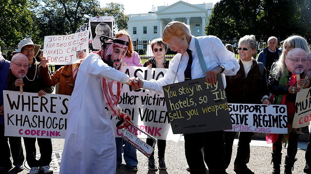 FILE PHOTO: Activists dressed as Saudi Crown Prince Mohammad bin Salman and U.S. President Donald Trump shake hands during a demonstration calling for sanctions against Saudi Arabia and to protest the disappearance of Saudi journalist Jamal Khashoggi, outside the White House in Washington, U.S., October 19, 2018. REUTERS/Leah Millis/File Photo

