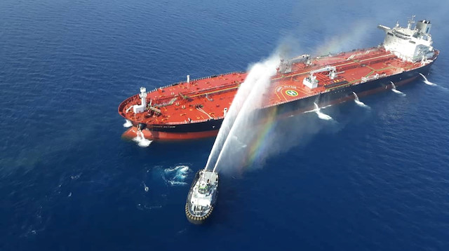 An Iranian navy boat tries to stop the fire of an oil tanker after it was attacked in the Gulf of Oman, June 13, 2019