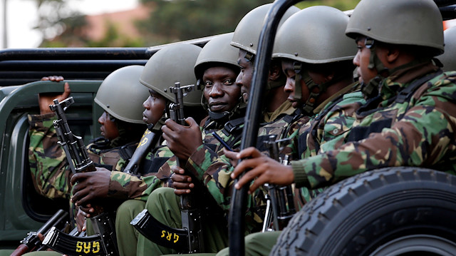 File photo: Kenyan police officers drive in their truck 