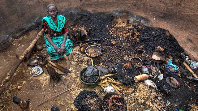 A woman sits in a burnt house during the clashes between nomads and residents in Deleij village, located in Wadi Salih locality, Central Darfur, Sudan June 11, 2019