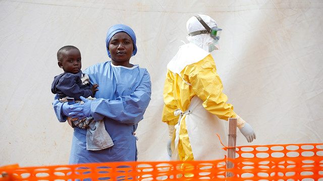 File photo: Mwamini Kahindo, an Ebola survivor working as a caregiver to babies who are confirmed Ebola cases, holds an infant outside the red zone at the Ebola treatment centre in Butembo, Democratic Republic of Congo