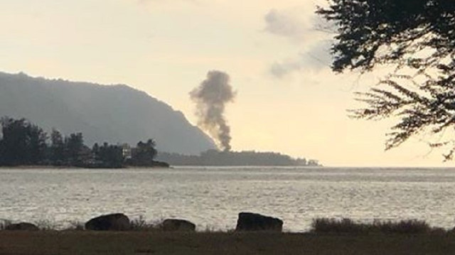 A plume of smoke rises after an airplane crash in Haleiwa, Hawaii, U.S