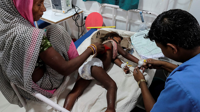 A child suffering from acute encephalitis syndrome is treated by a doctor at a hospital in Muzaffarpur, in the eastern state of Bihar, India, June 20, 2019. REUTERS/Alasdair Pal

