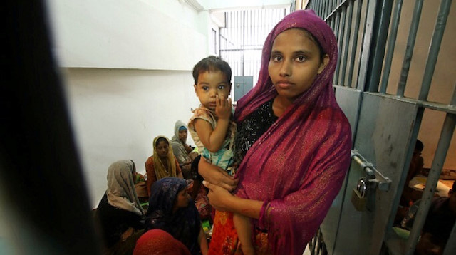 File photo: A Rohingya woman and her baby are seen detained in a police station after a fishing boat carrying more than sixty Rohingya refugees was found beached at Rawi island, part of Tarutao national park in the province of Satun, Thailand
