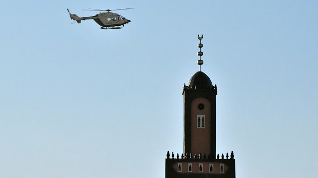 A Spanish civil guard helicopter flies near a mosque during an operation 