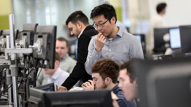 Traders looks at financial information on computer screens on the IG Index trading floor in London, Britain February 6, 2018.