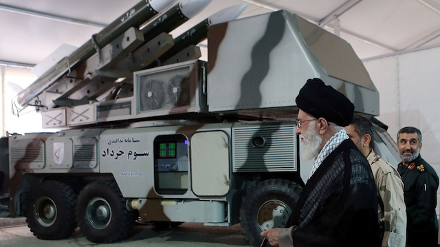 Iran's Supreme Leader Ayatollah Ali Khamenei is seen near a "3 Khordad" system which is said to had been used to shoot down a U.S. military drone, according to news agency Fars, in this undated handout picture. Fars news/