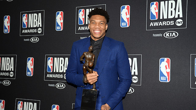 Milwaukee Bucks forward Giannis Antetokounmpo poses with his NBA most valuable player award at the 2019 NBA Awards 