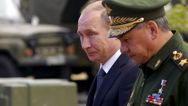 Russian President Vladimir Putin (L) and Defence Minister Sergei Shoigu