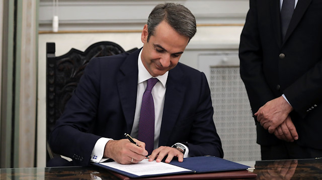 Newly appointed Greek Prime Minister Kyriakos Mitsotakis signs the protocol, following his swearing-in ceremony at the Presidential Palace in Athens, Greece July 8, 2019.