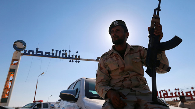 A member of Libyan forces loyal to eastern commander Khalifa Haftar holds a weapon as he sits on a car in front of the gate at Zueitina oil terminal in Zueitina, west of Benghazi, Libya September 14, 2016. Picture taken September 14, 2016. REUTERS/Esam Omran Al-Fetori

