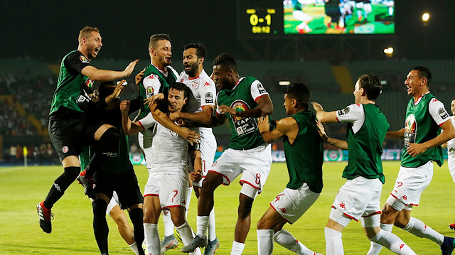 Tunisia's Youssef Msakni celebrates scoring their second goal with team mates