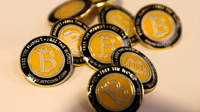 FILE PHOTO: Bitcoin.com buttons are seen displayed on the floor of the Consensus 2018 blockchain technology conference in New York City, New York, U.S., May 16, 2018. REUTERS/Mike Segar/File Photo

