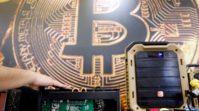 File photo: A cryptocurrency mining computer is seen in front of bitcoin logo during the annual Computex computer exhibition in Taipei, Taiwan 