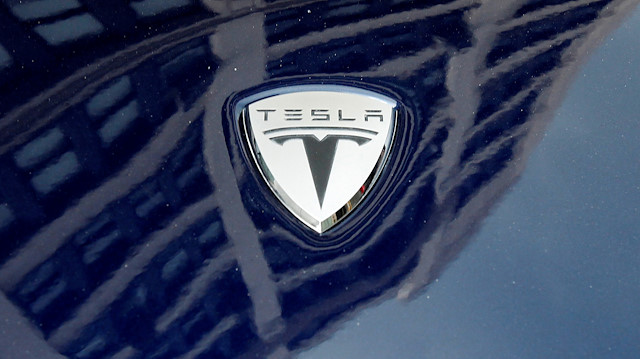 File photo: A logo of Tesla Motors on an electric car model is seen outside a showroom in New York