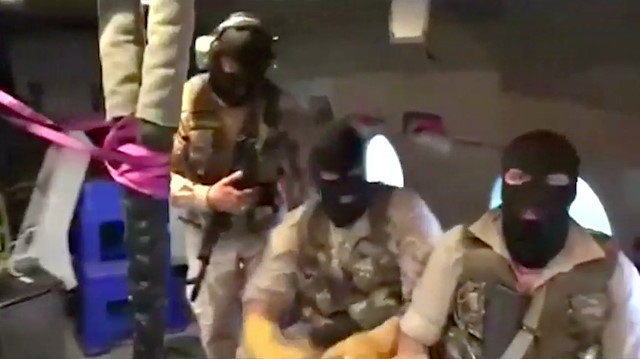 Iranian Revolutionary Guard troops wearing ski masksare seen on board a helicopter flying over British-flagged tanker Stena Impero near the strait of Hormuz July 19, 2019, in this still image taken from video. 