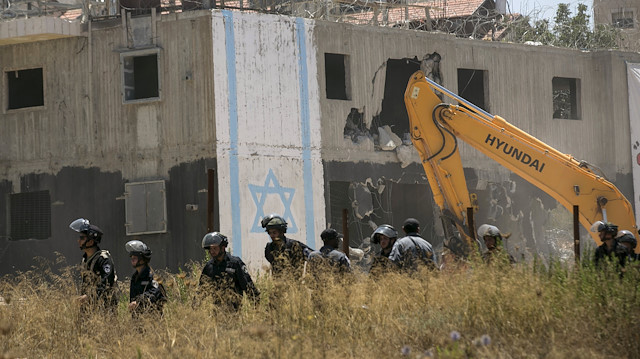 Reuters
Israeli paramilitary police secure the area during the demolition of two partially-built dwellings 