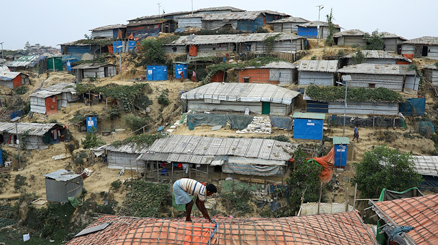 File photo: A Rohingya refugee repairs the roof of his shelter at the Balukhali refugee camp